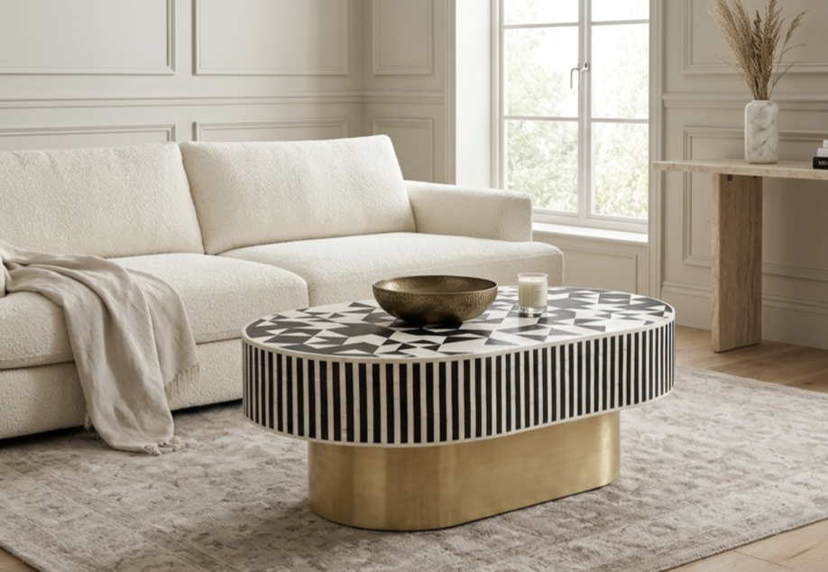 Black and white bone inlay oval coffee table with geometric design and brass pedestal base