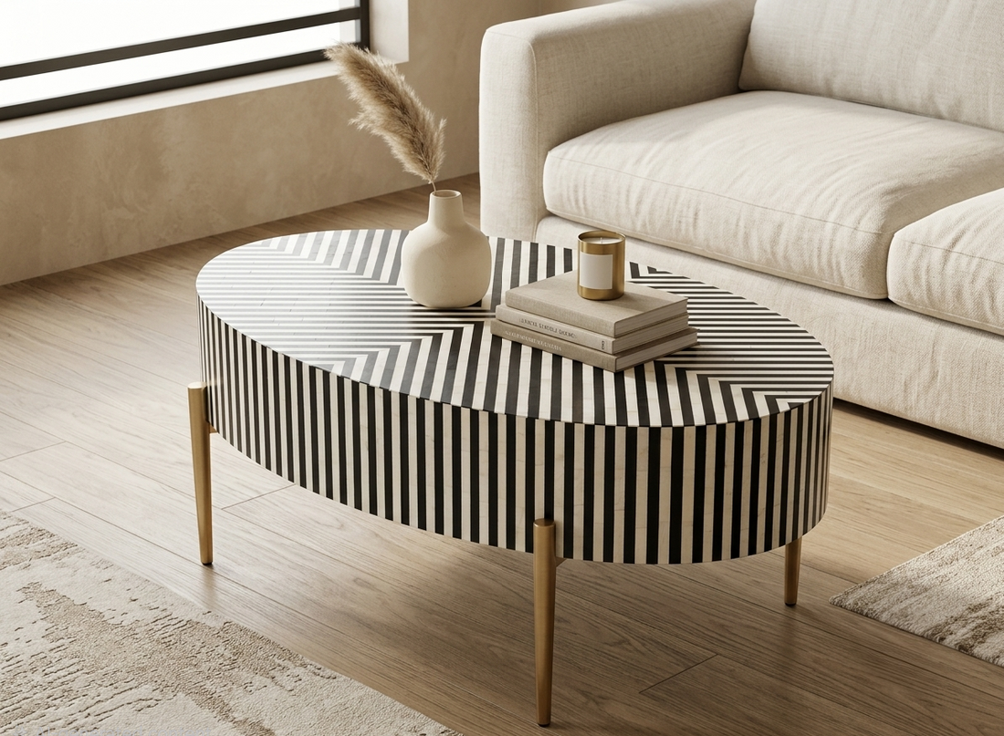 Black and white bone inlay oval coffee table with geometric stripe pattern and gold powder-coated metal legs